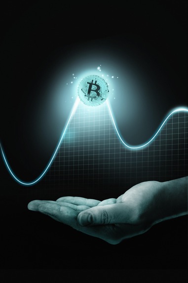 Hand holding cryptocurrency coin